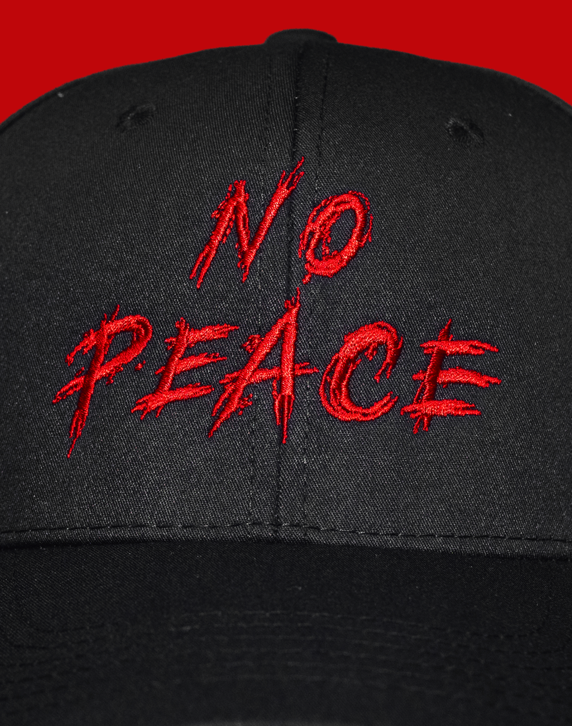 Black cap with red 'No Peace' text on a red background